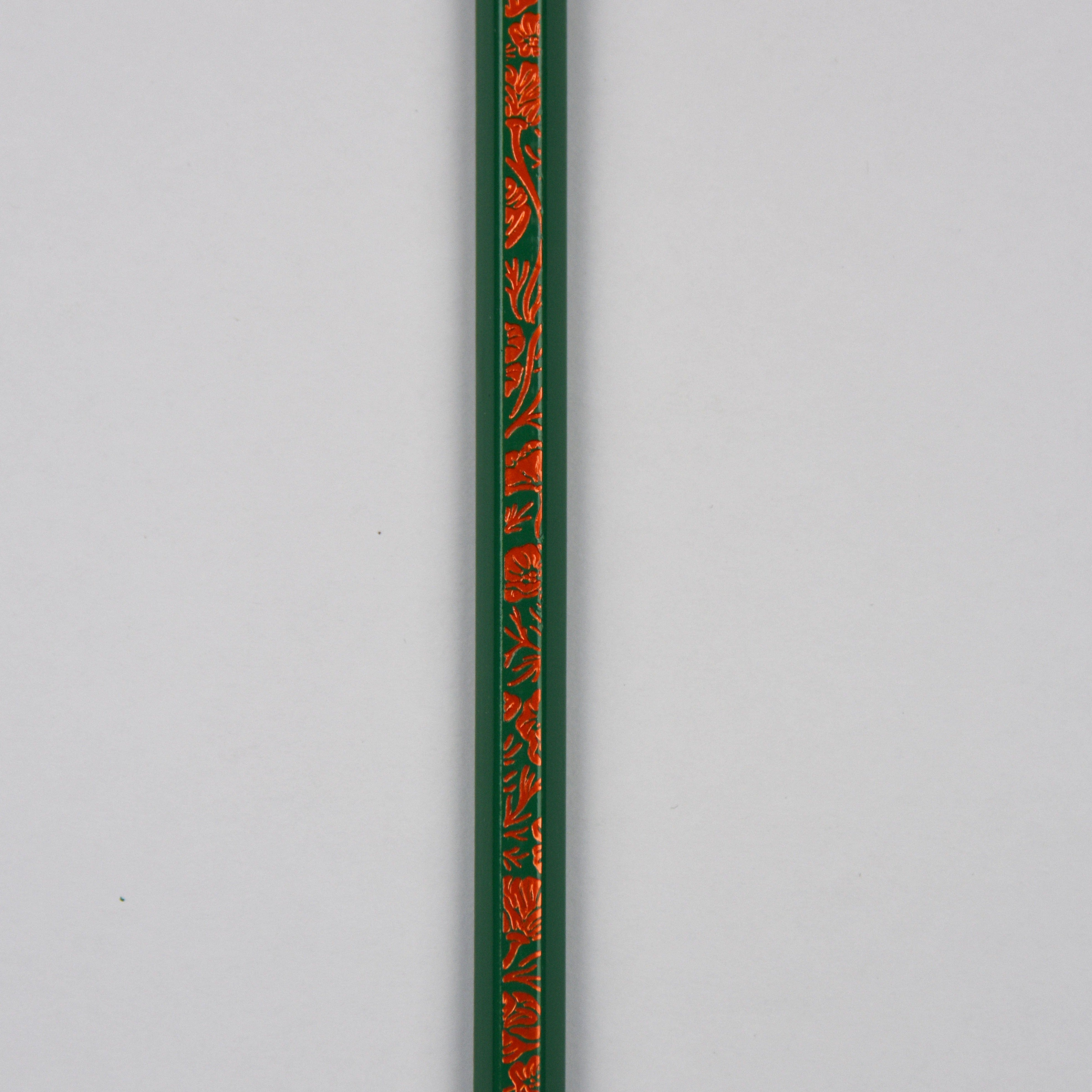 close up of green pencil with flower motif