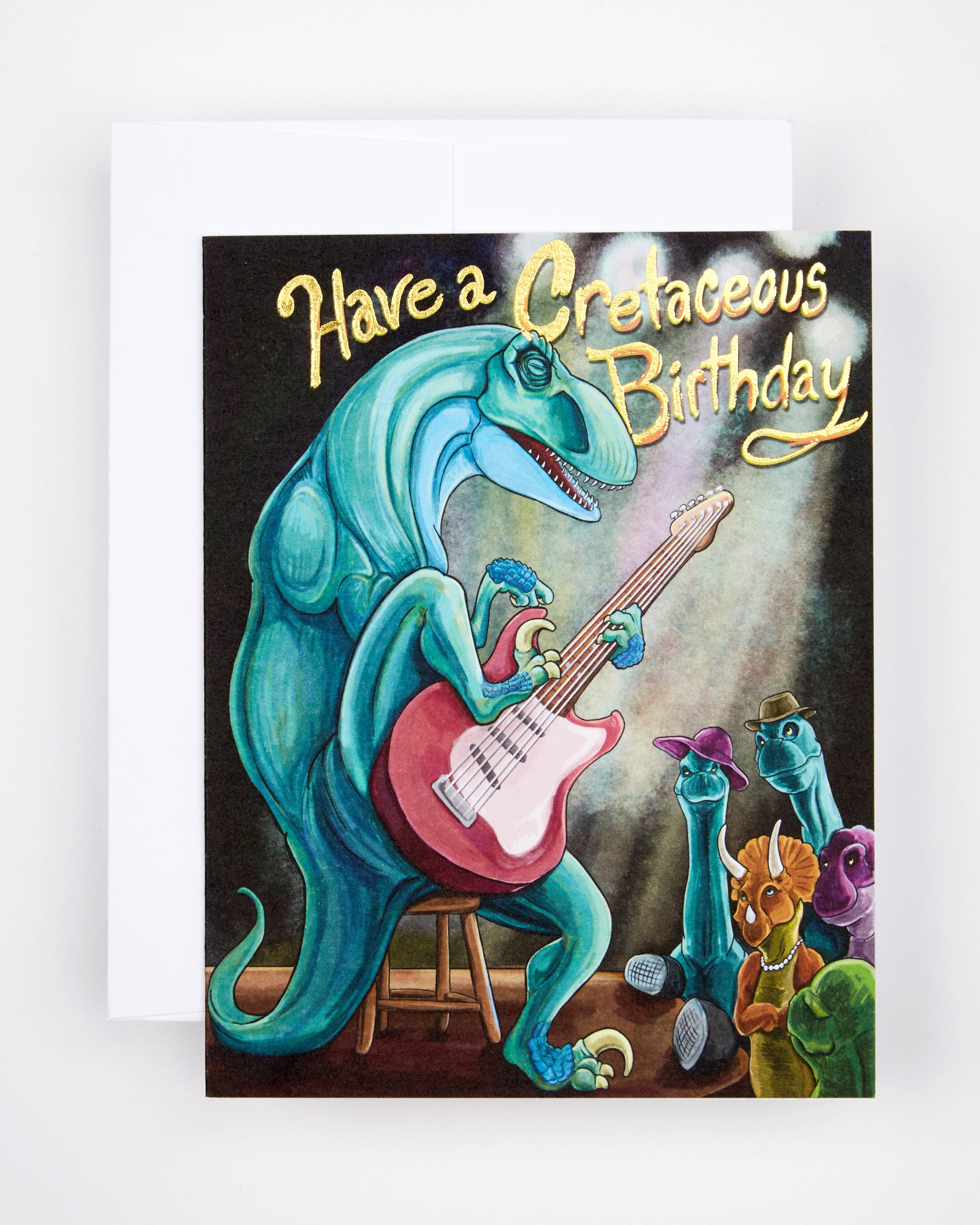 Greeting card with the text Have a Cretaceous Birthday and a guitar-playing dinosaur