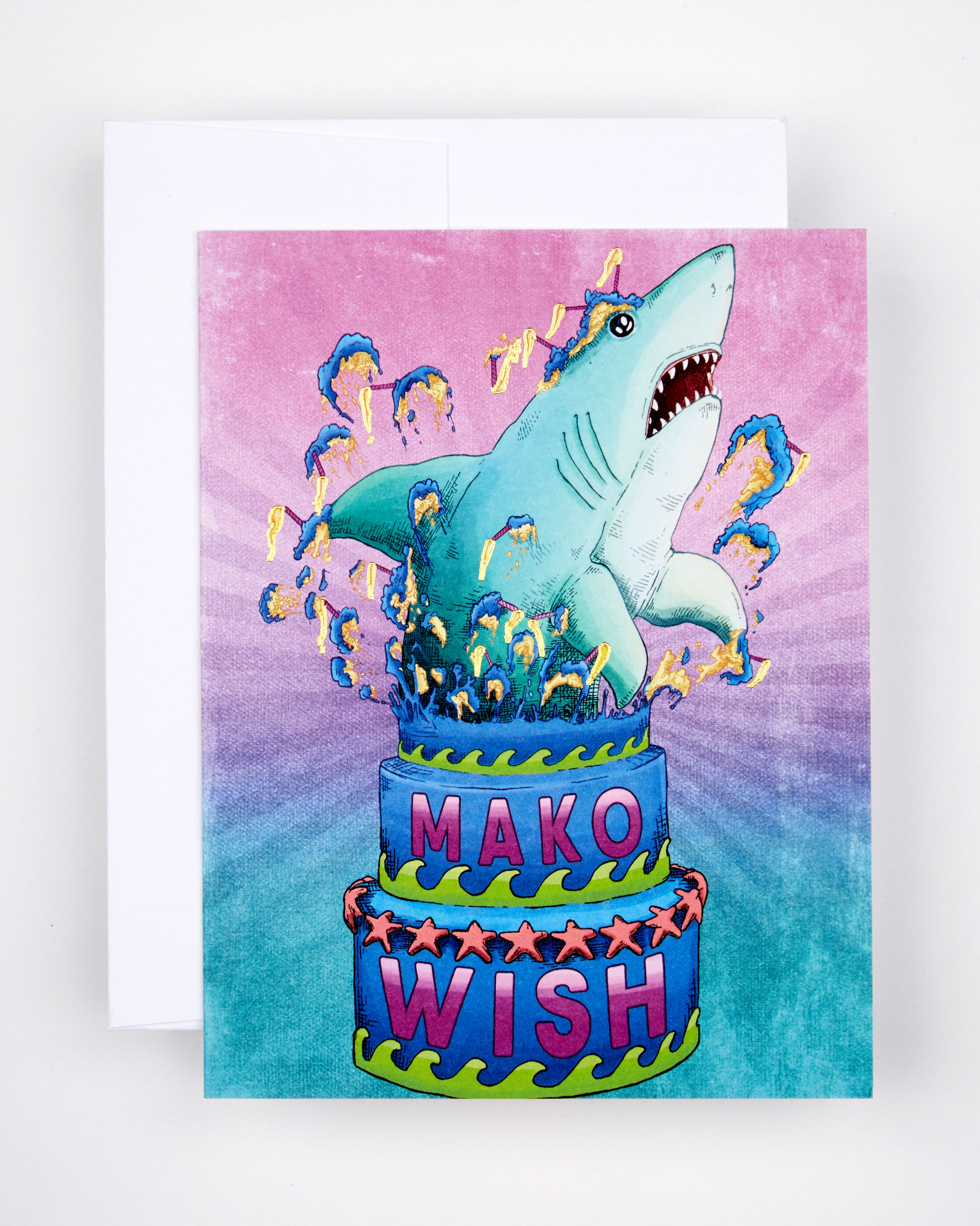 Greeting card with the text Mako Wish on a cake from which a shark erupts