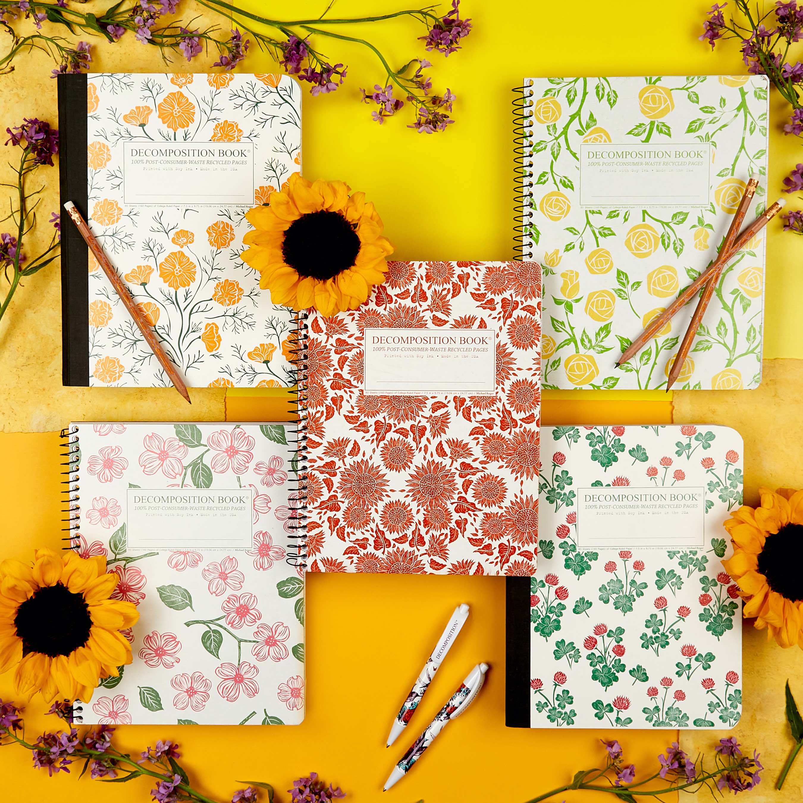 Five colorful notebooks and writing utensils