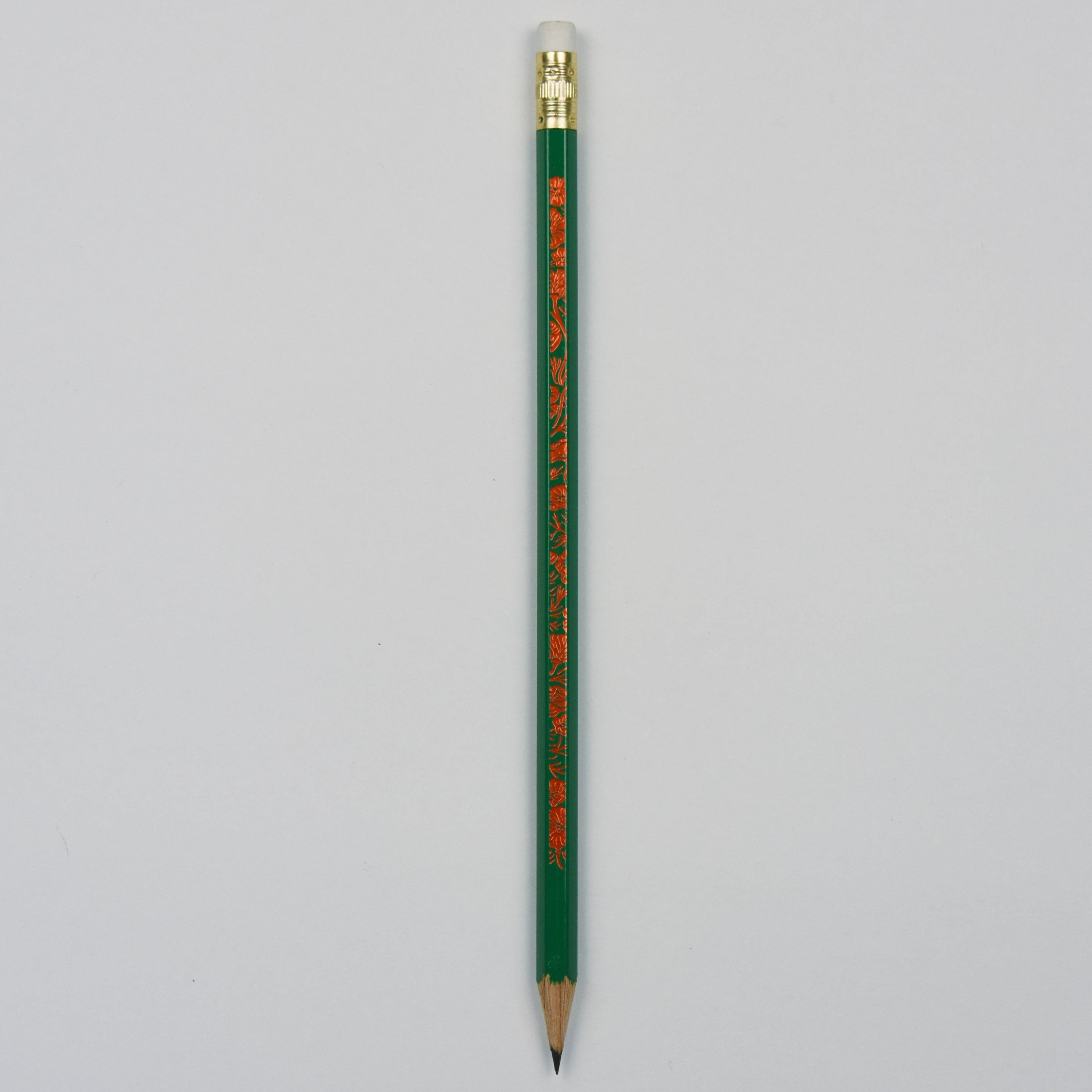 front of the green pencil with flower motif