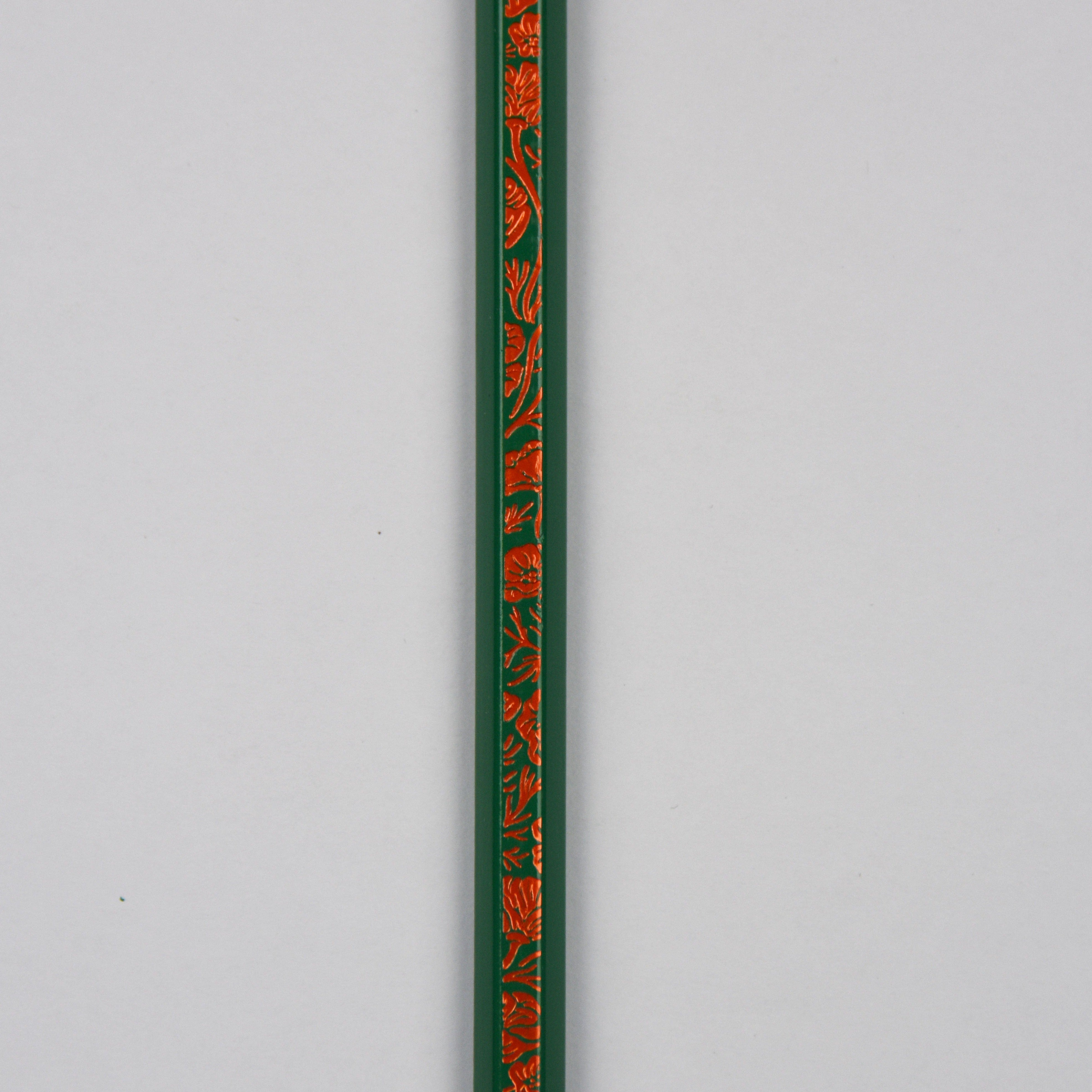 close up of green pencil with flower motif