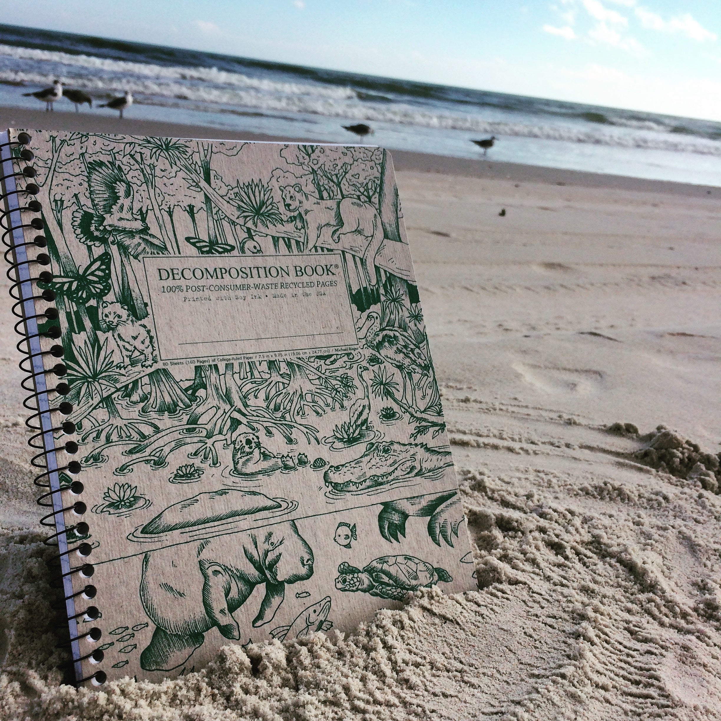 Spiral notebook lying on the beach