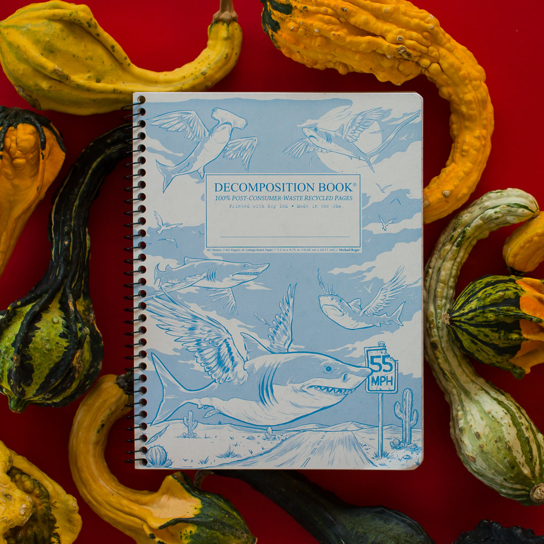 Spiral notebook printed with winged sharks in blue