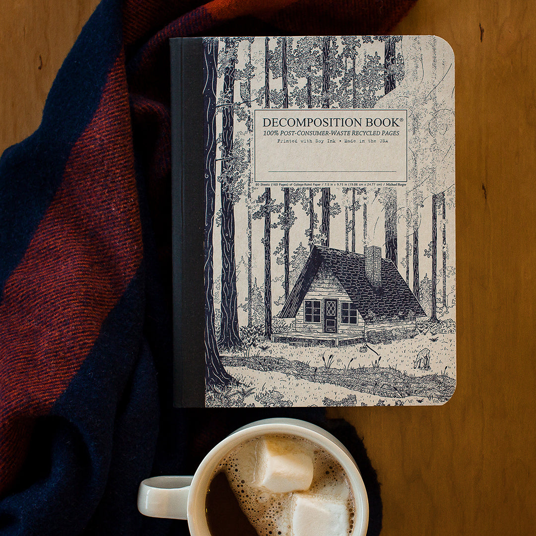 Composition notebook printed with a woodsy cabin in blue