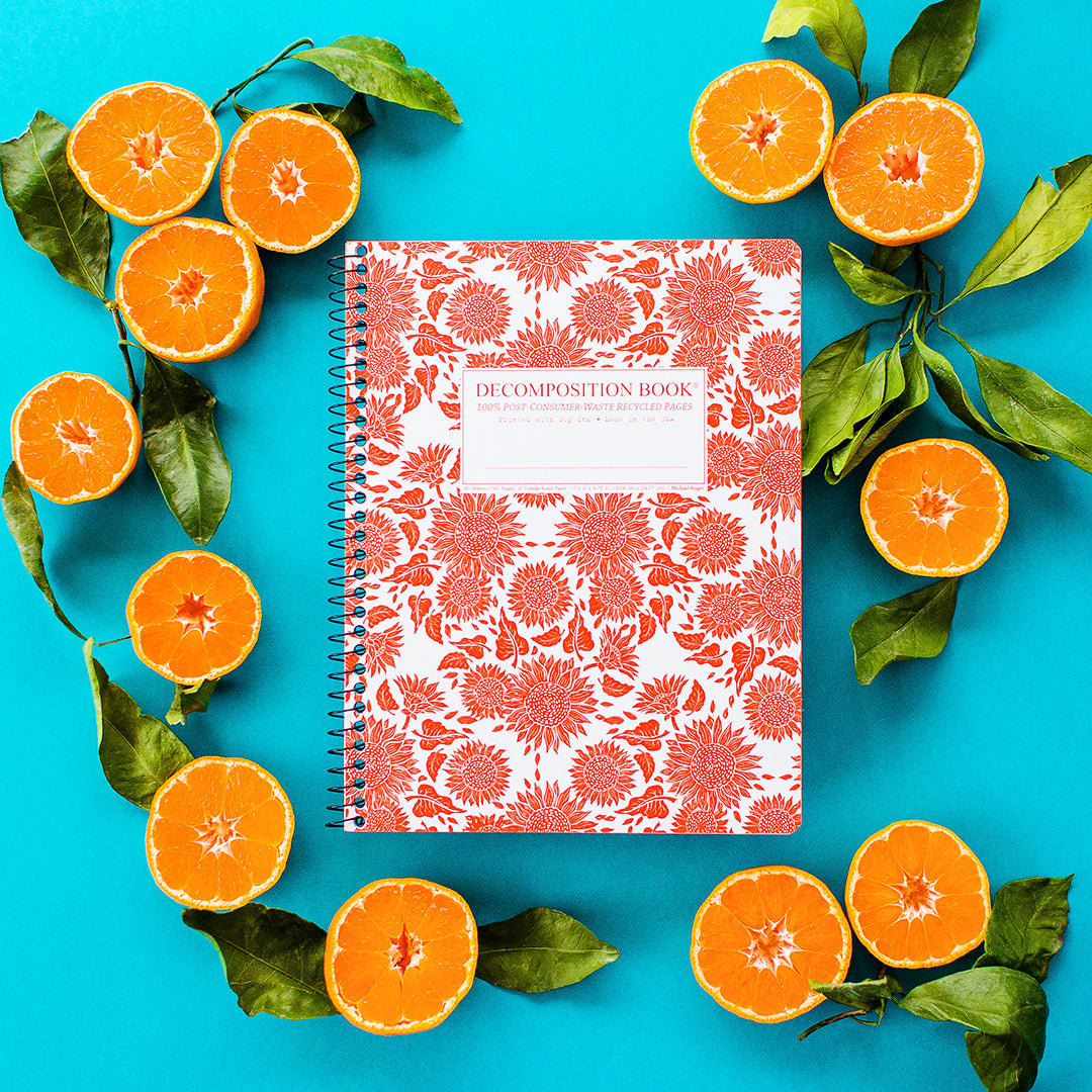 Spiral notebook printed with a bright orange sunflower pattern