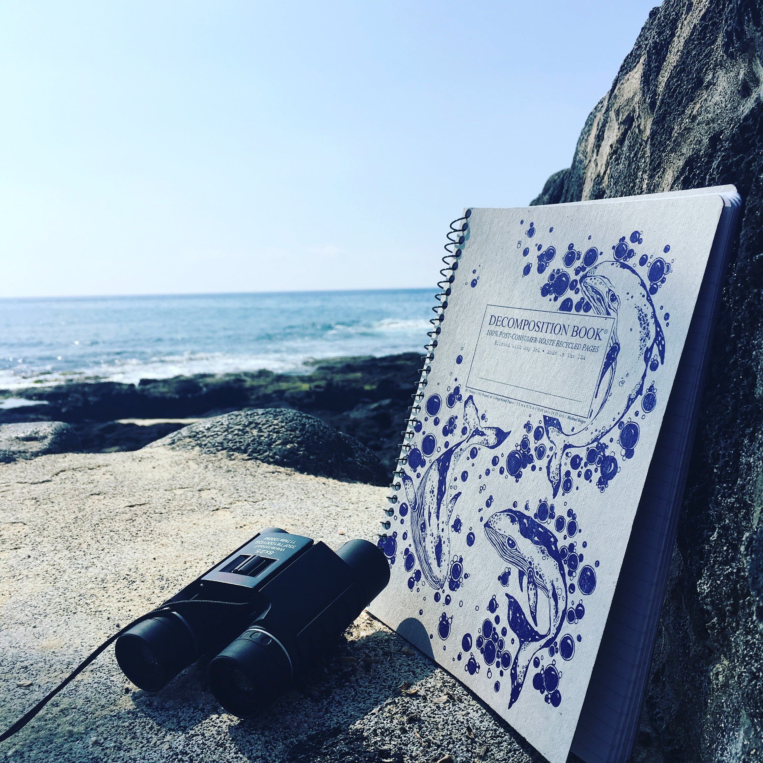 Spiral notebook printed with whales and bubbles in purple