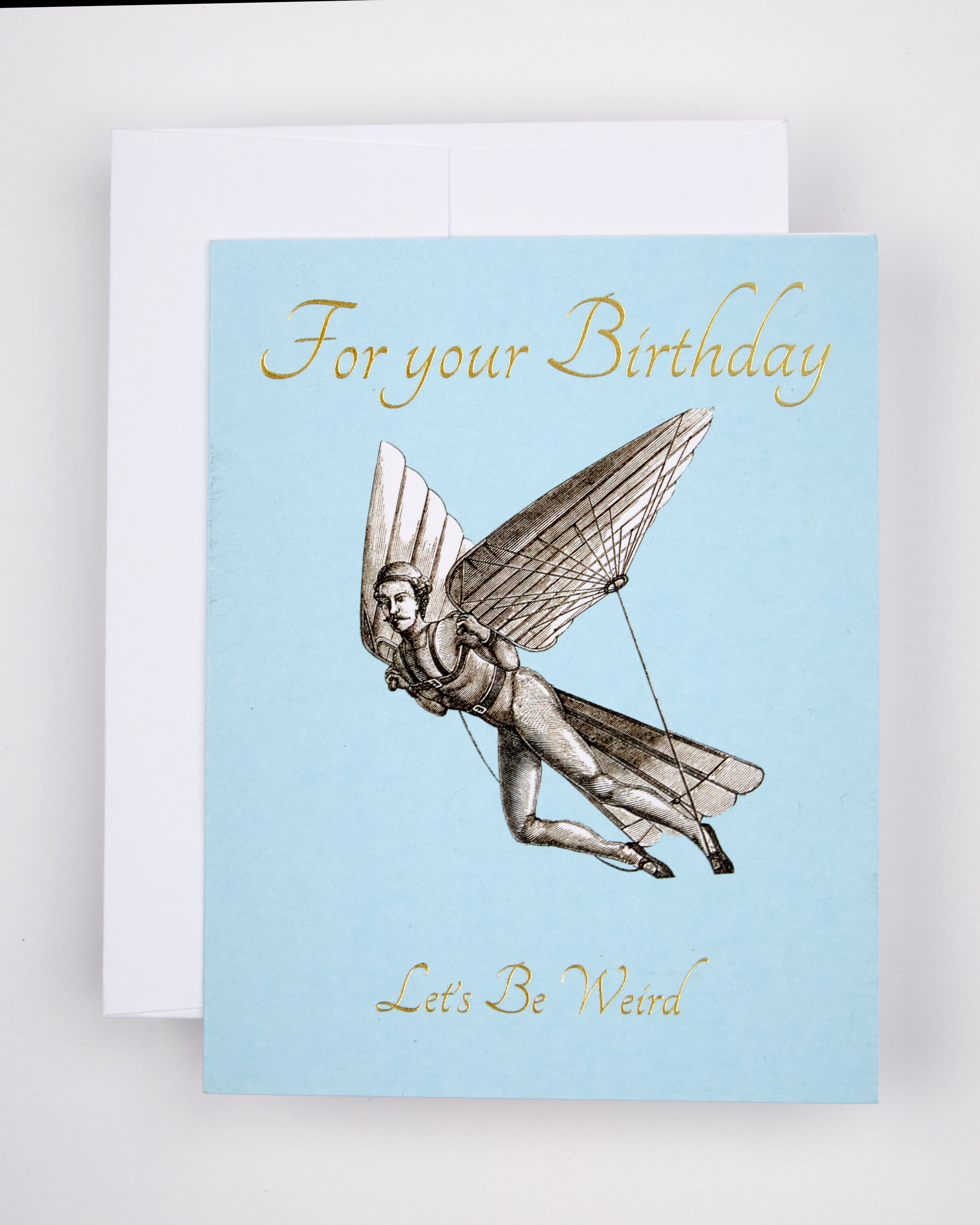 Greeting card with the text For Your Birthday Let's Be Weird and a flying man