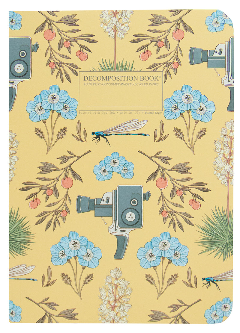 Notebook printed with movie cameras, dragonflies and oranges