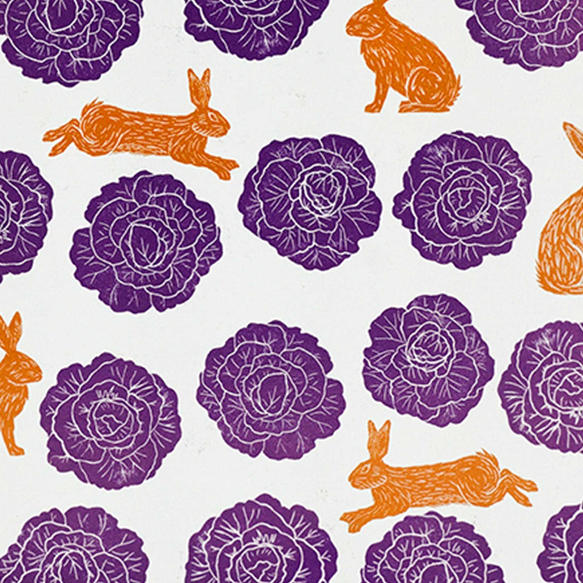 Closeup of a pattern of purple cabbages and orange rabbits