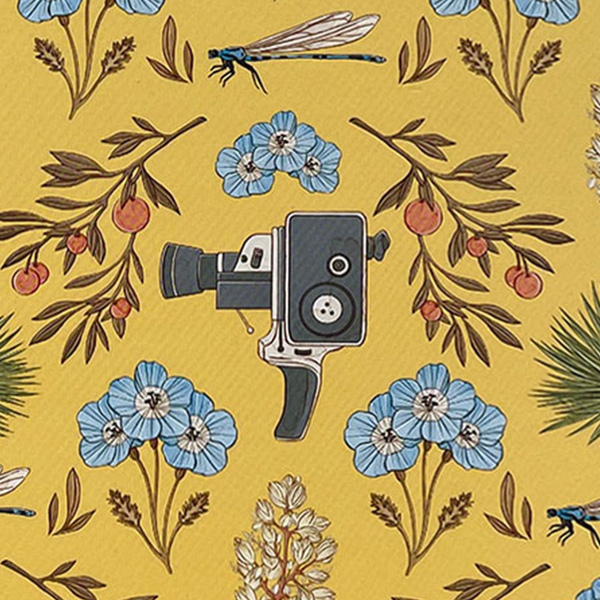 Closeup of with movie cameras, dragonflies and oranges printed on yellow
