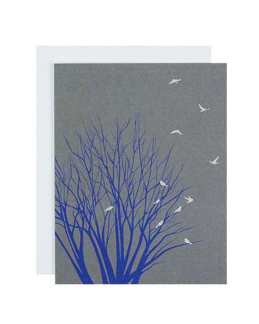 Greeting card printed with a silhouette of a tree with birds
